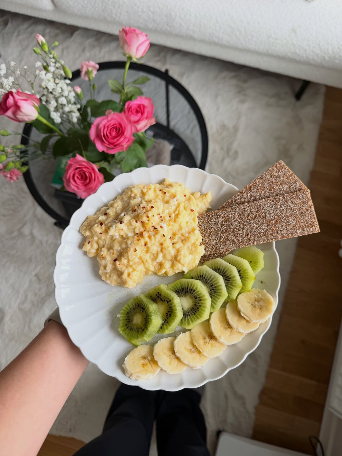 Scandinavian breakfast with scrambled eggs, crispbread and pink roses