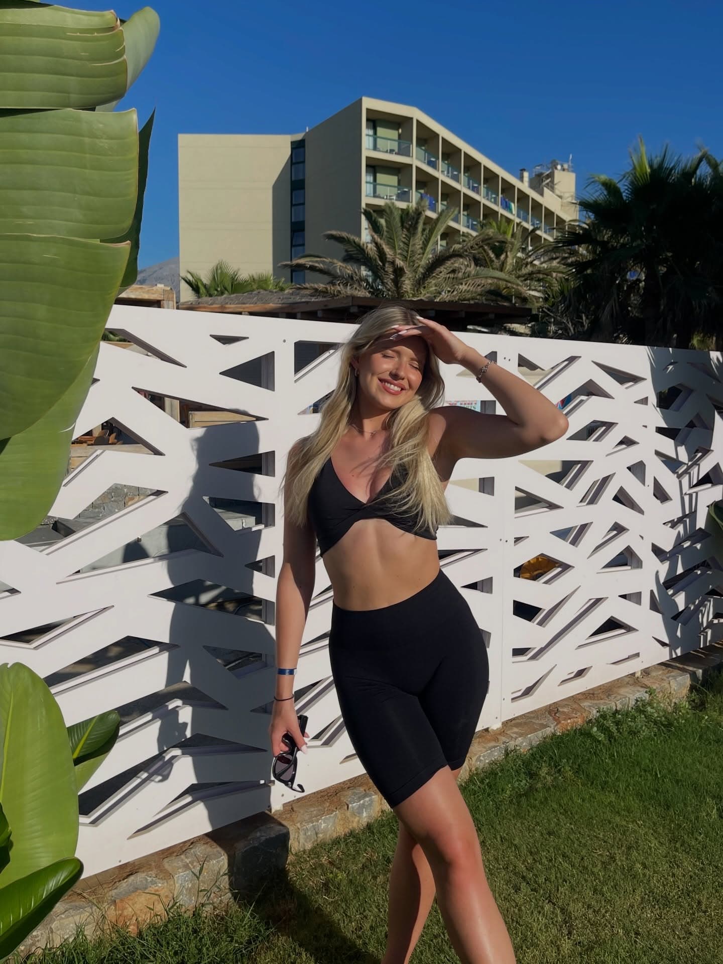 Hanna training on a hotel balcony, black sports bra and bike shorts